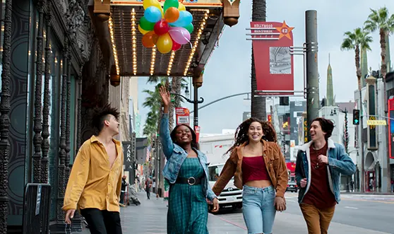 friends-having-fun-with-balloons-while-out-city copy